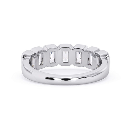 A picture of a seven stone diamond wedding ring with emerald cut diamonds that are bezel set in white gold or platinum on a white background with a view of the underside of the ring.