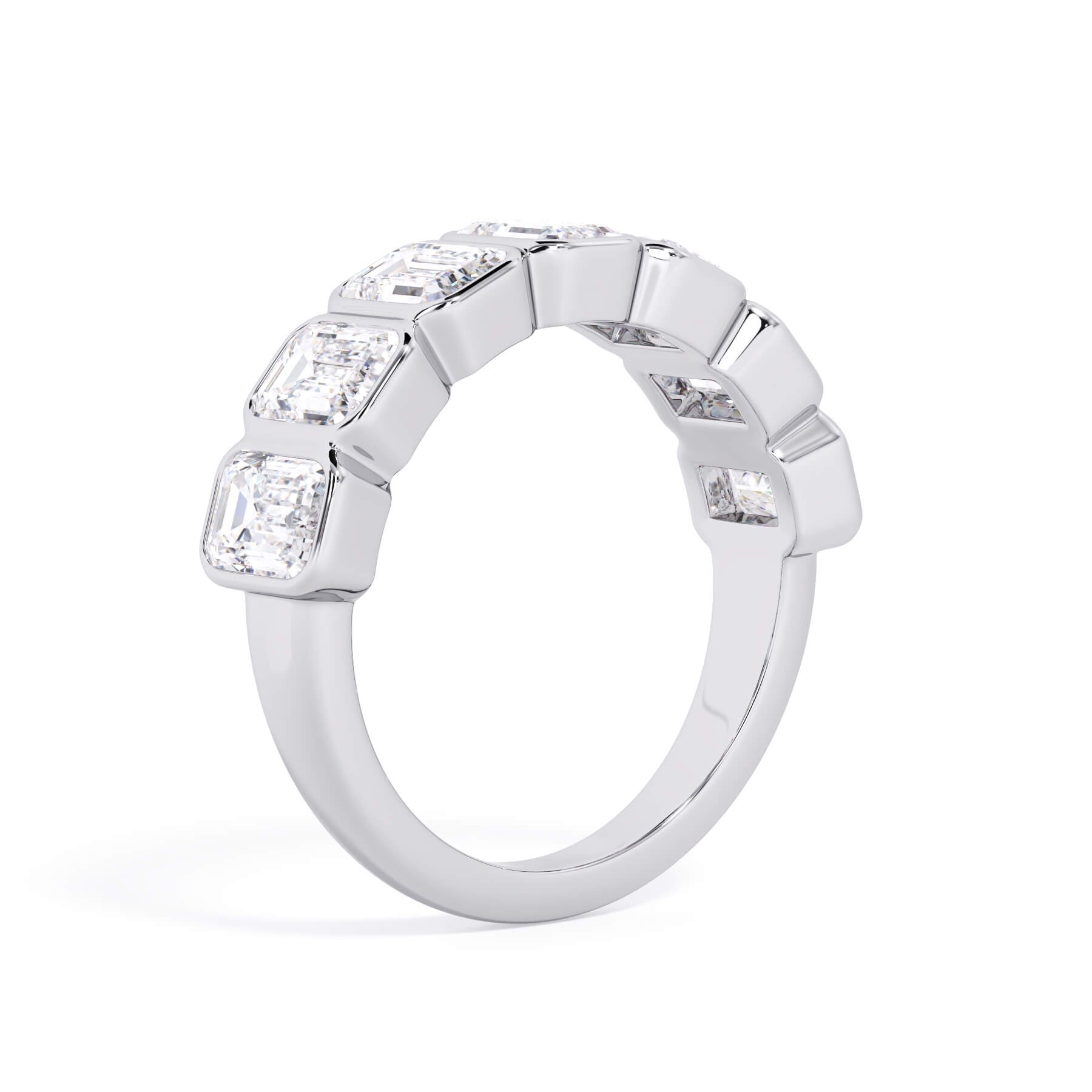 A picture of a seven stone diamond wedding ring with emerald cut diamonds that are bezel set in white gold or platinum on a white background with a slightly angled, through the finger view.