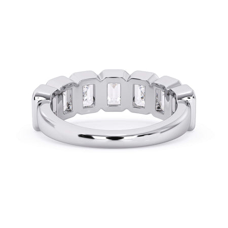 A picture of a seven stone diamond wedding ring with emerald cut diamonds that are bezel set in white gold or platinum on a white background with a view of the underside of the ring.