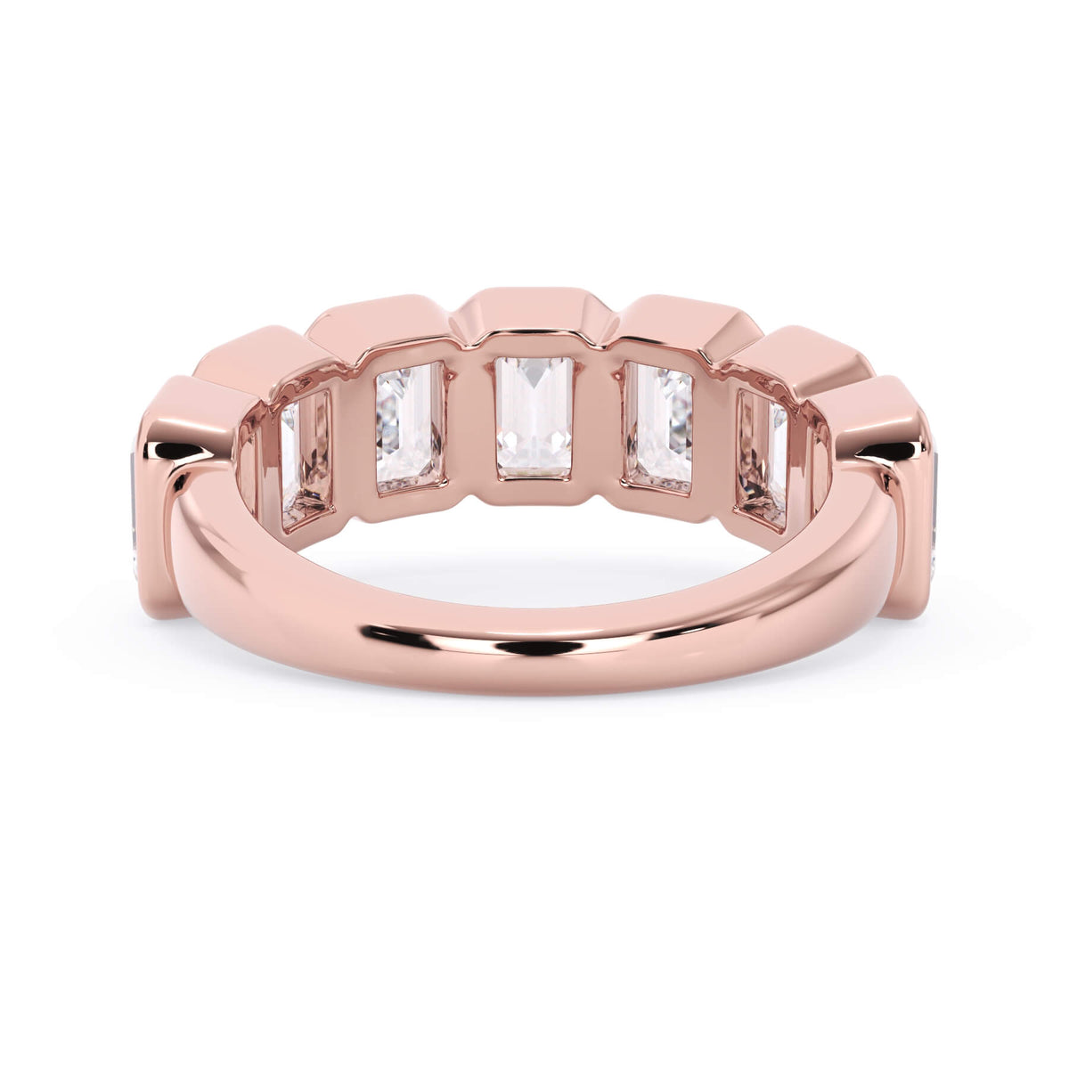 A picture of a seven stone diamond wedding ring with emerald cut diamonds that are bezel set in rose gold on a white background with a view of the underside of the ring.