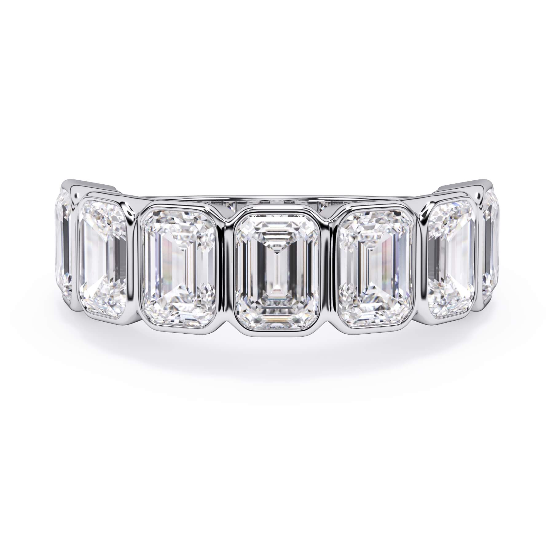 A picture of a seven stone diamond wedding ring with emerald cut diamonds that are bezel set in white gold or platinum on a white background with the ring facing forward, lying down.