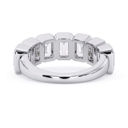 A picture of a seven stone diamond wedding ring with emerald cut diamonds that are bezel set in white gold or platinum on a white background with a view of the underside of the ring.