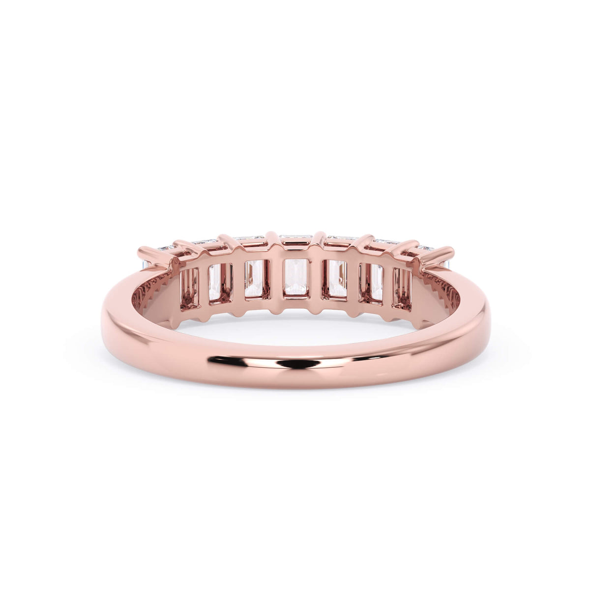 A picture of a seven stone diamond wedding ring with emerald cut diamonds that are shared prong set in rose gold on a white background with a view of the underside of the ring.