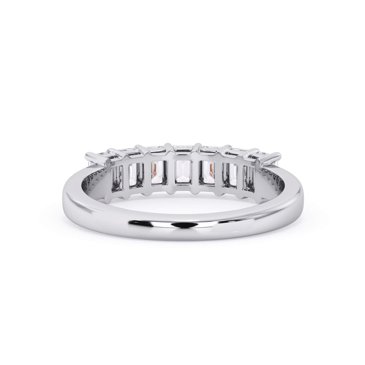 A picture of a seven stone diamond wedding ring with emerald cut diamonds that are shared prong set in white gold or platinum on a white background with a view of the underside of the ring.