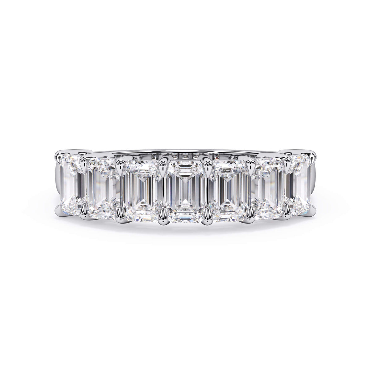 A picture of a seven stone diamond wedding ring with emerald cut diamonds that are shared prong set in white gold or platinum on a white background with the ring facing forward, lying down.