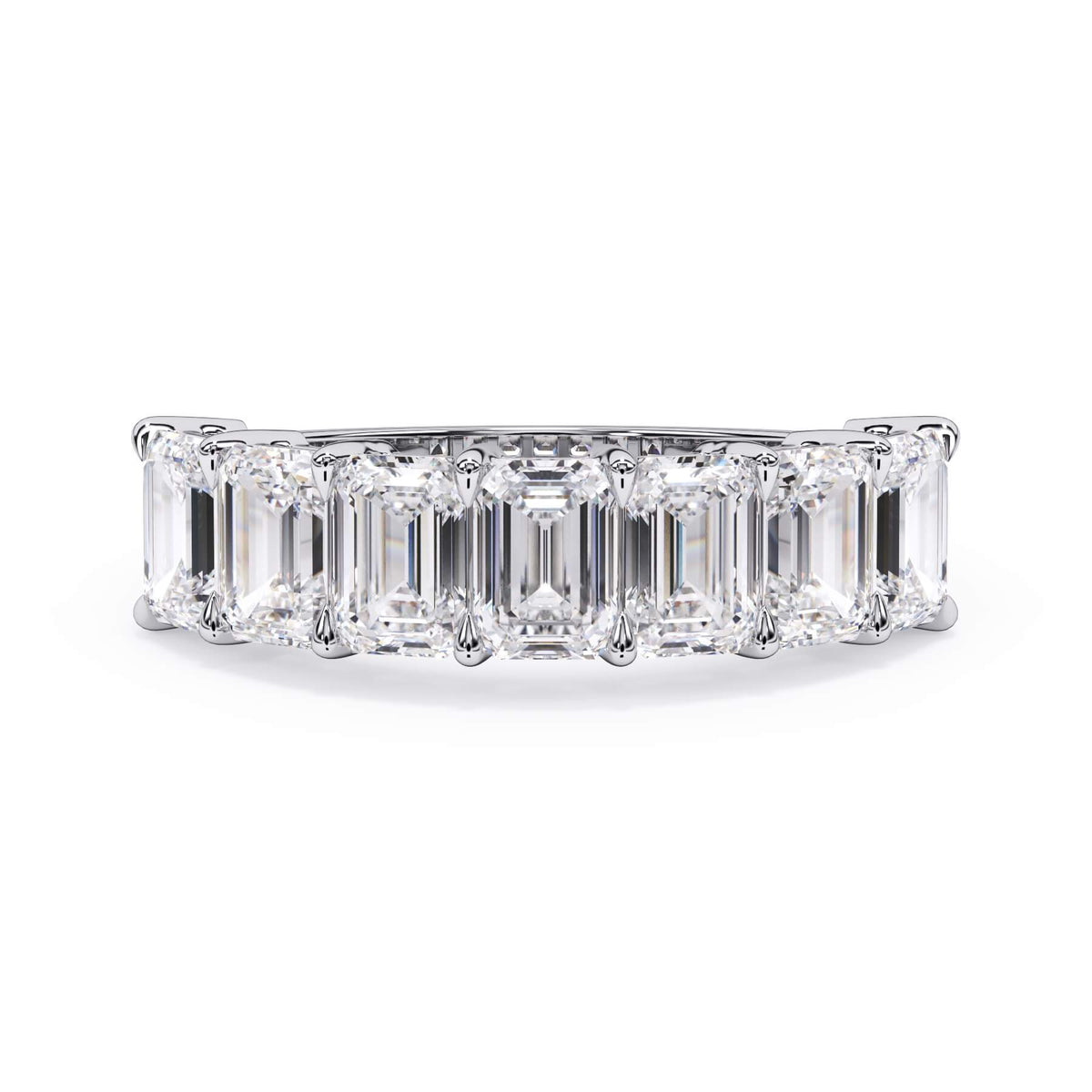 A picture of a seven stone diamond wedding ring with emerald cut diamonds that are shared prong set in white gold or platinum on a white background with the ring facing forward, lying down.