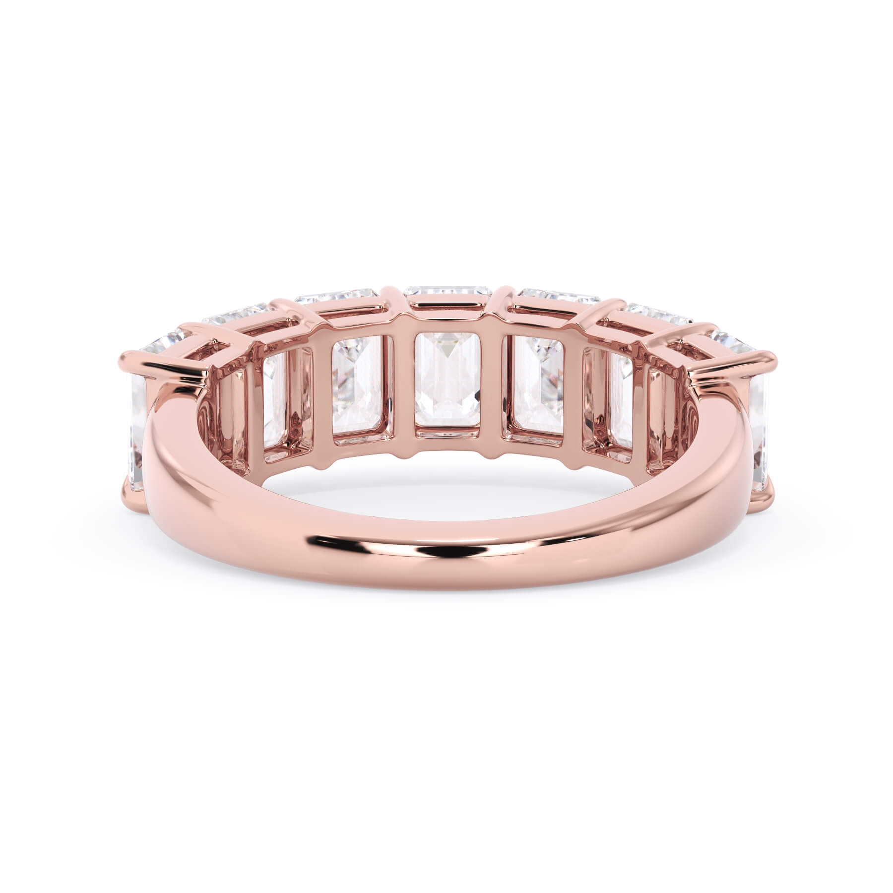 A picture of a seven stone diamond wedding ring with emerald cut diamonds that are shared prong set in rose gold on a white background with a view of the underside of the ring.
