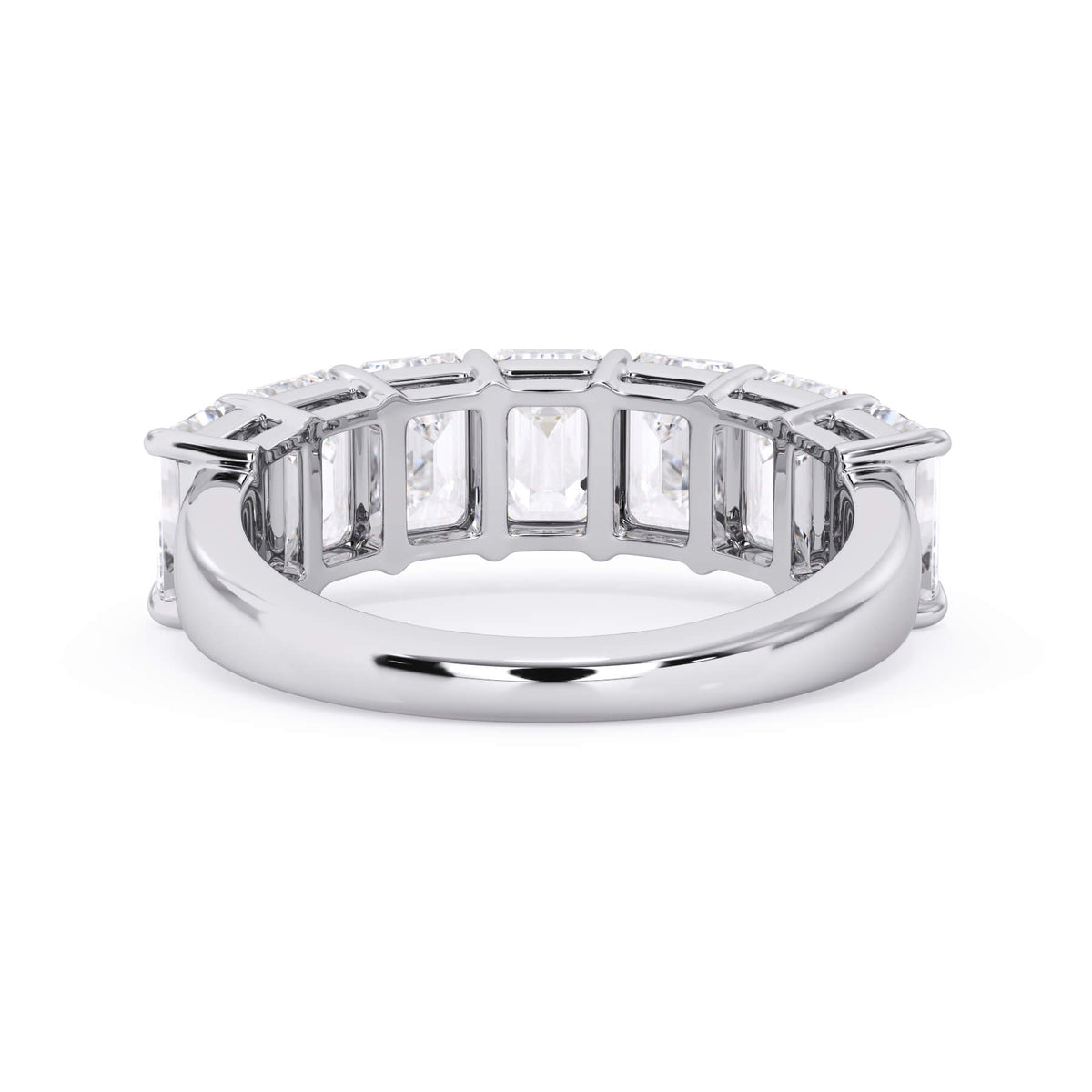 A picture of a seven stone diamond wedding ring with emerald cut diamonds that are shared prong set in white gold or platinum on a white background with a view of the underside of the ring.