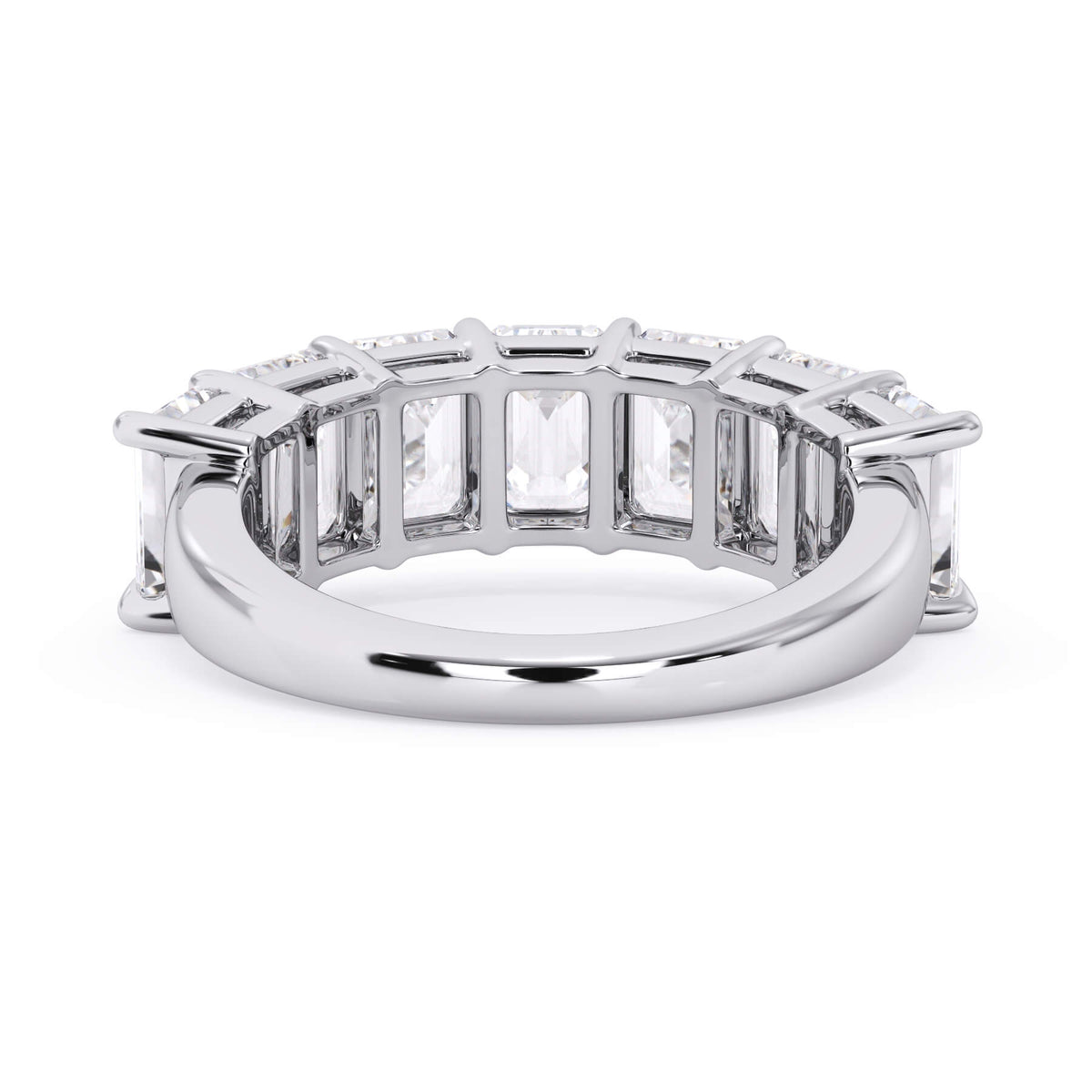 A picture of a seven stone diamond wedding ring with emerald cut diamonds that are shared prong set in white gold or platinum on a white background with a view of the underside of the ring.