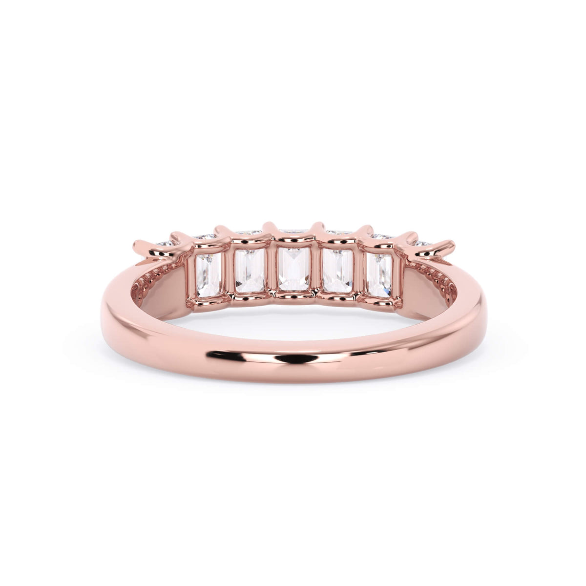A picture of a seven stone diamond wedding ring with emerald cut diamonds that are U prong set in rose gold on a white background with a view of the underside of the ring.
