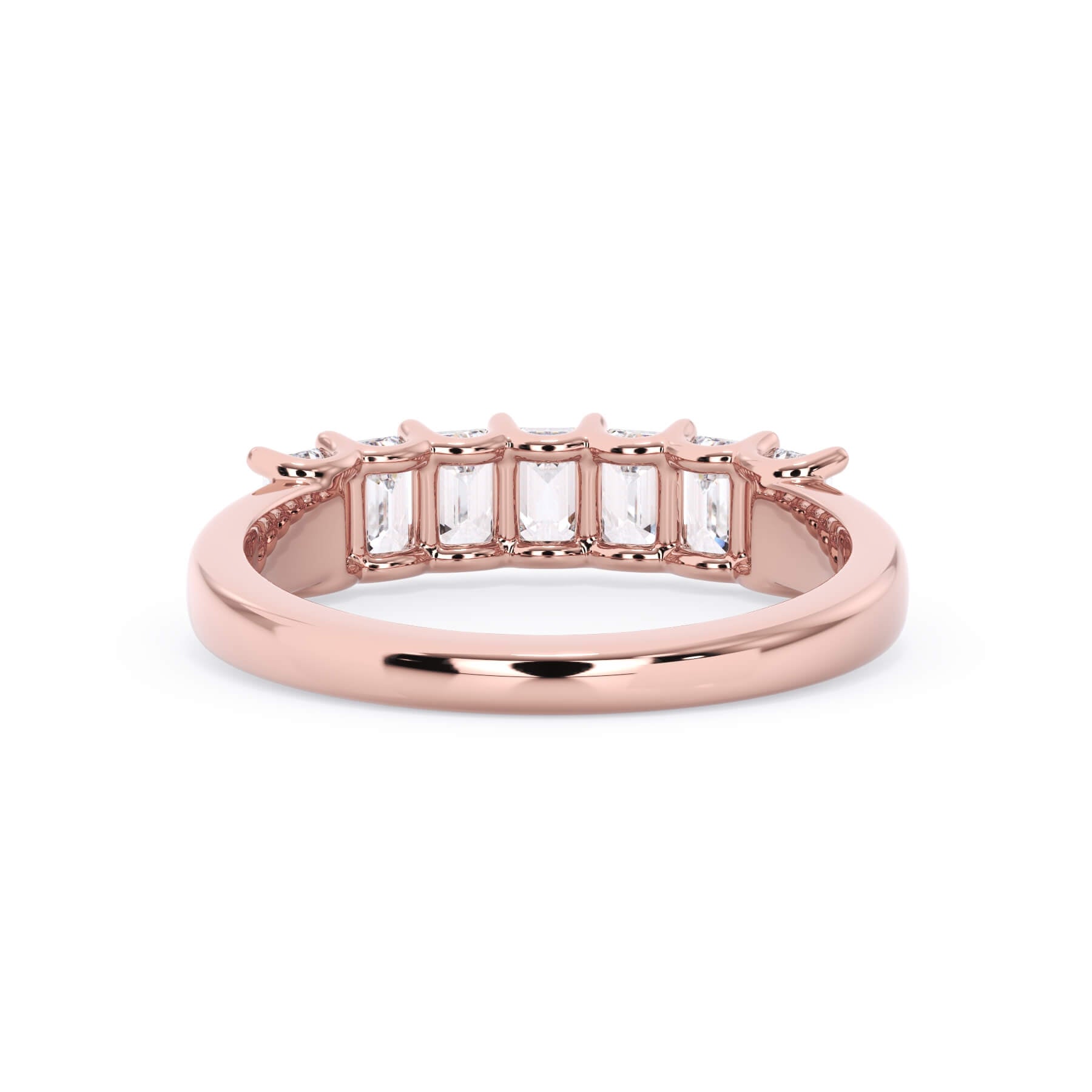 A picture of a seven stone diamond wedding ring with emerald cut diamonds that are U prong set in rose gold on a white background with a view of the underside of the ring.