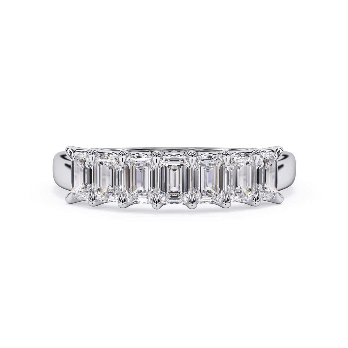 A picture of a seven stone diamond wedding ring with emerald cut diamonds that are U prong set in white gold or platinum on a white background with the ring facing forward, lying down.