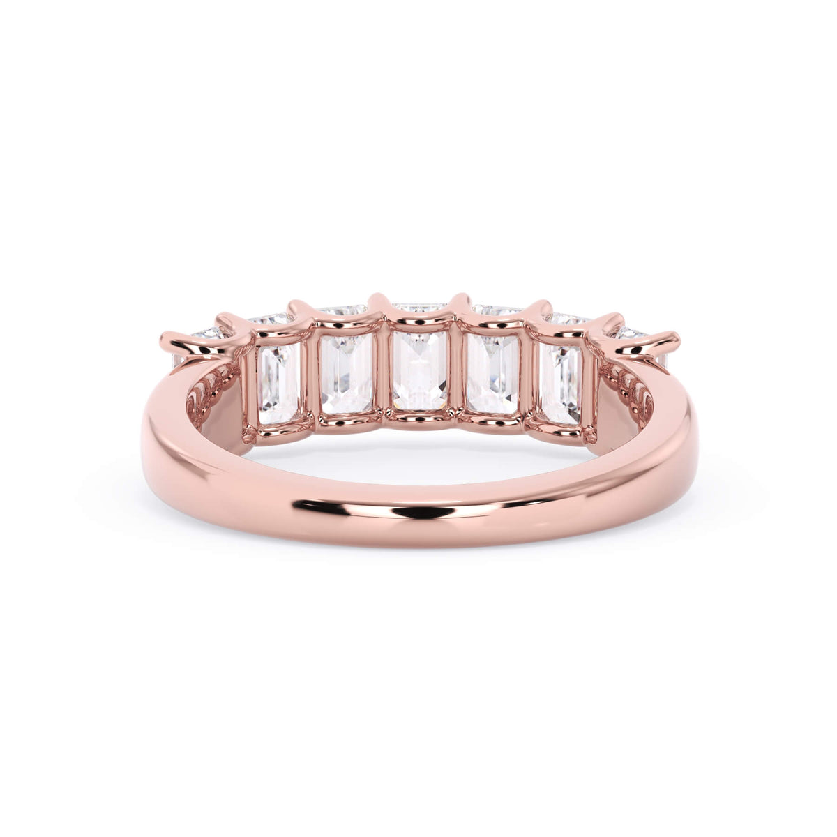 A picture of a seven stone diamond wedding ring with emerald cut diamonds that are U prong set in rose gold on a white background with a view of the underside of the ring.