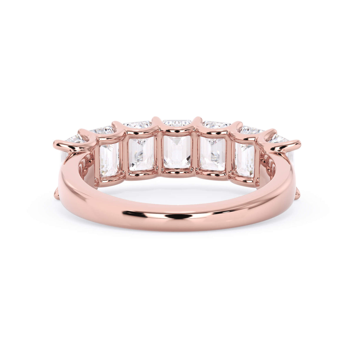 A picture of a seven stone diamond wedding ring with emerald cut diamonds that are U prong set in rose gold on a white background with a view of the underside of the ring.