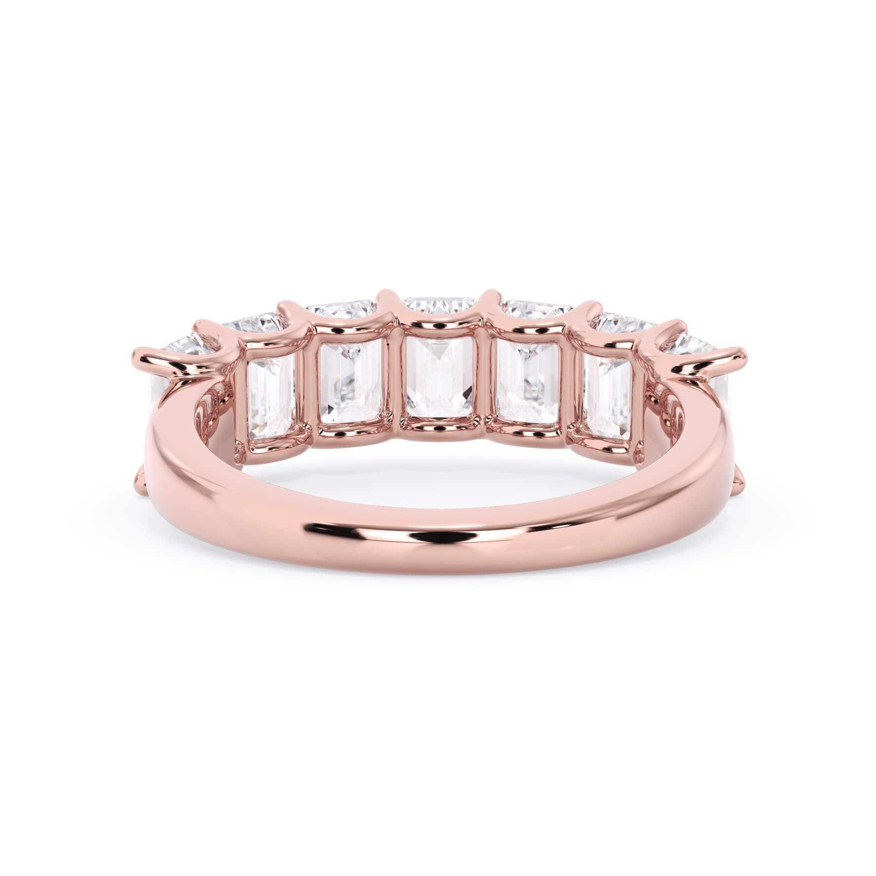 A picture of a seven stone diamond wedding ring with emerald cut diamonds that are U prong set in rose gold on a white background with a view of the underside of the ring.