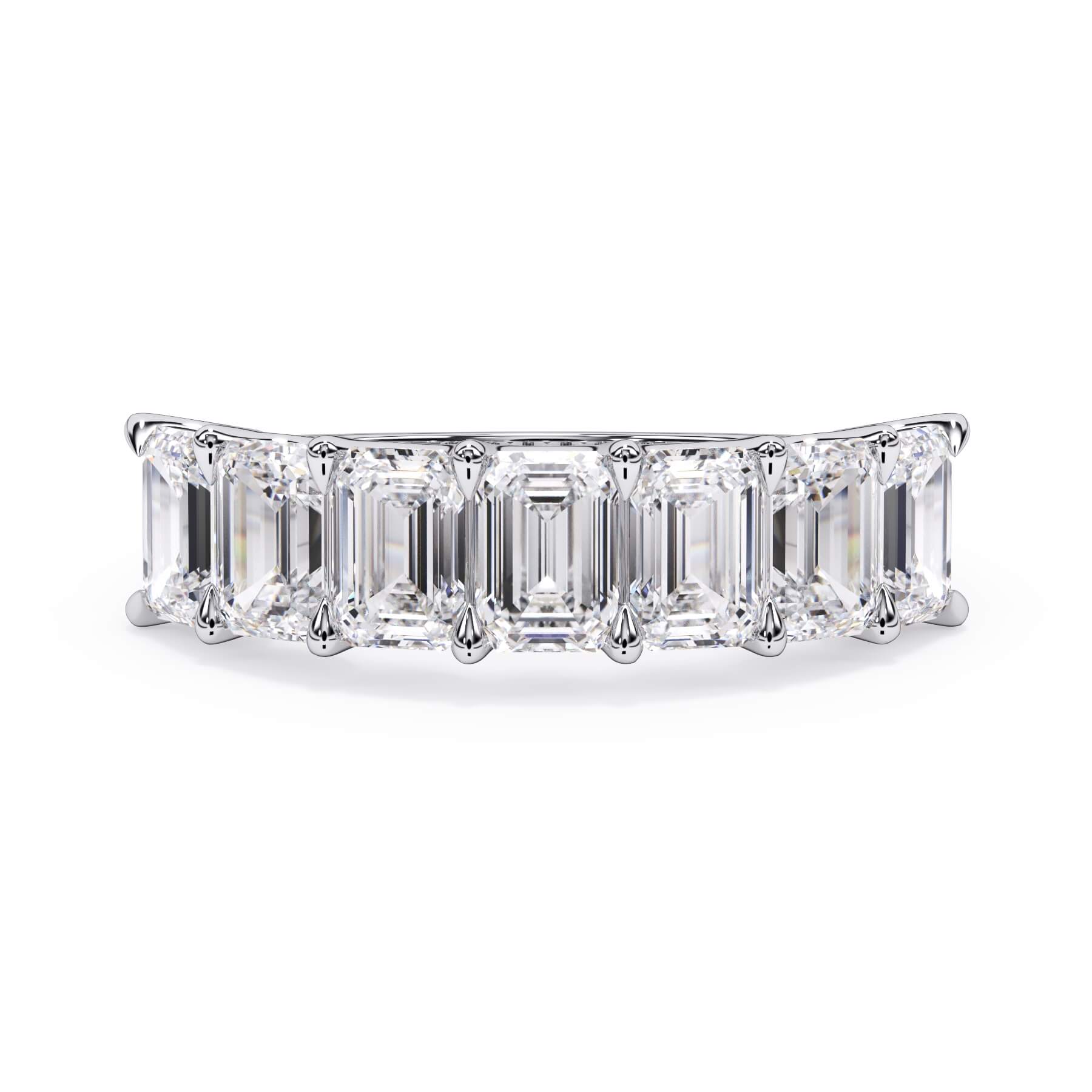 A picture of a seven stone diamond wedding ring with emerald cut diamonds that are U prong set in white gold or platinum on a white background with the ring facing forward, lying down.