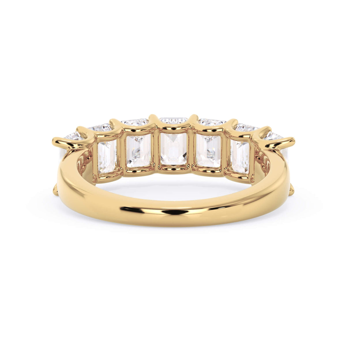 A picture of a seven stone diamond wedding ring with emerald cut diamonds that are U prong set in yellow gold on a white background with a view of the underside of the ring.