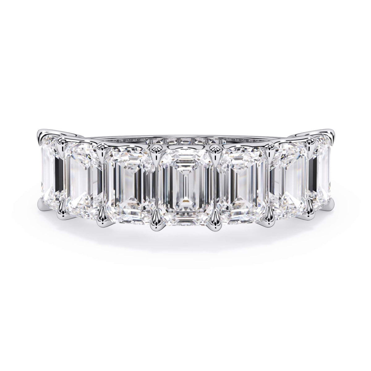 A picture of a seven stone diamond wedding ring with emerald cut diamonds that are U prong set in white gold or platinum on a white background with the ring facing forward, lying down.