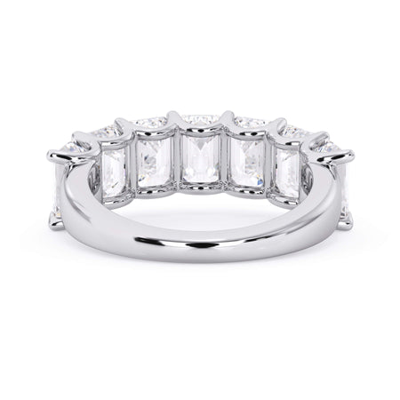 A picture of a seven stone diamond wedding ring with emerald cut diamonds that are U prong set in white gold or platinum on a white background with a view of the underside of the ring.