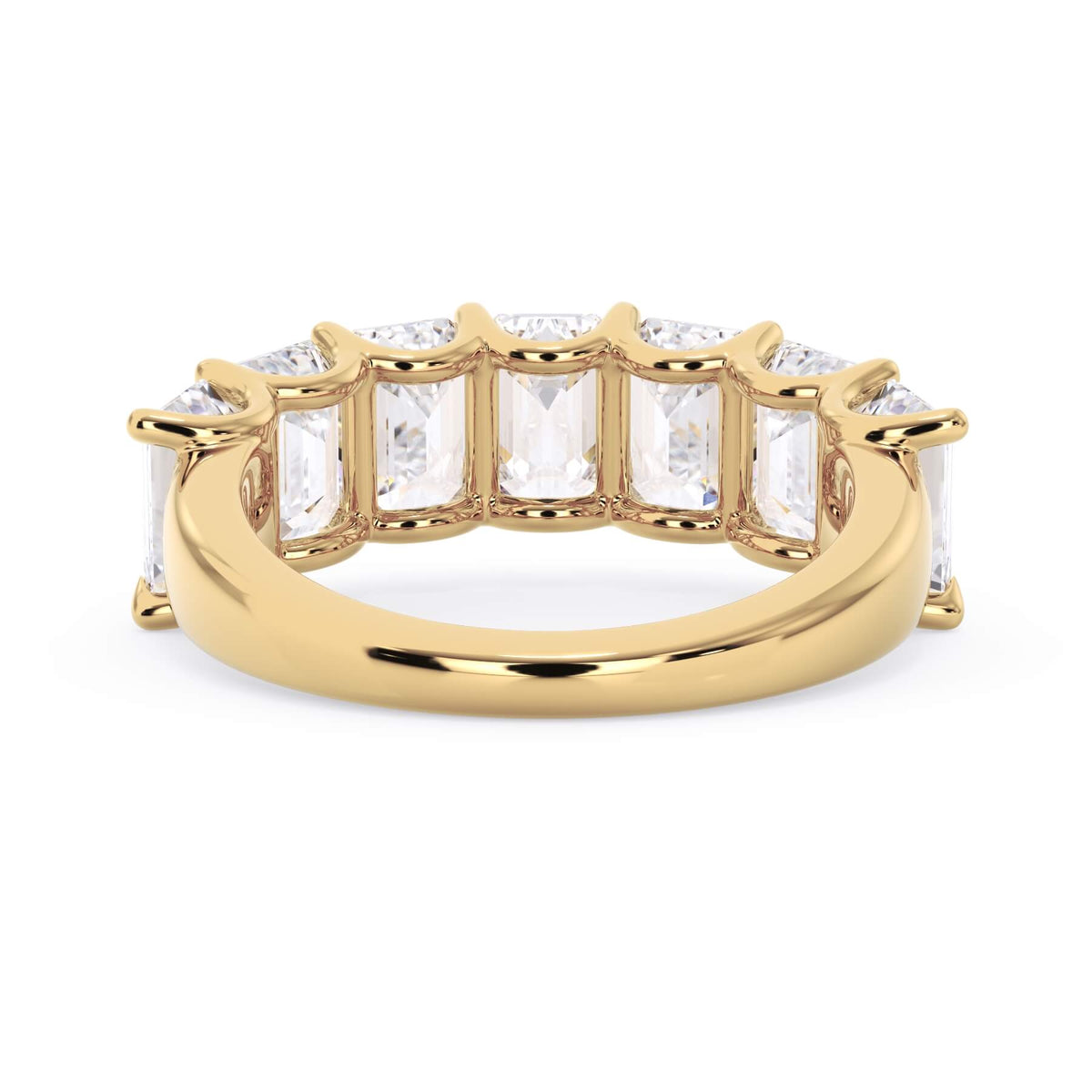 A picture of a seven stone diamond wedding ring with emerald cut diamonds that are U prong set in yellow gold on a white background with a view of the underside of the ring.