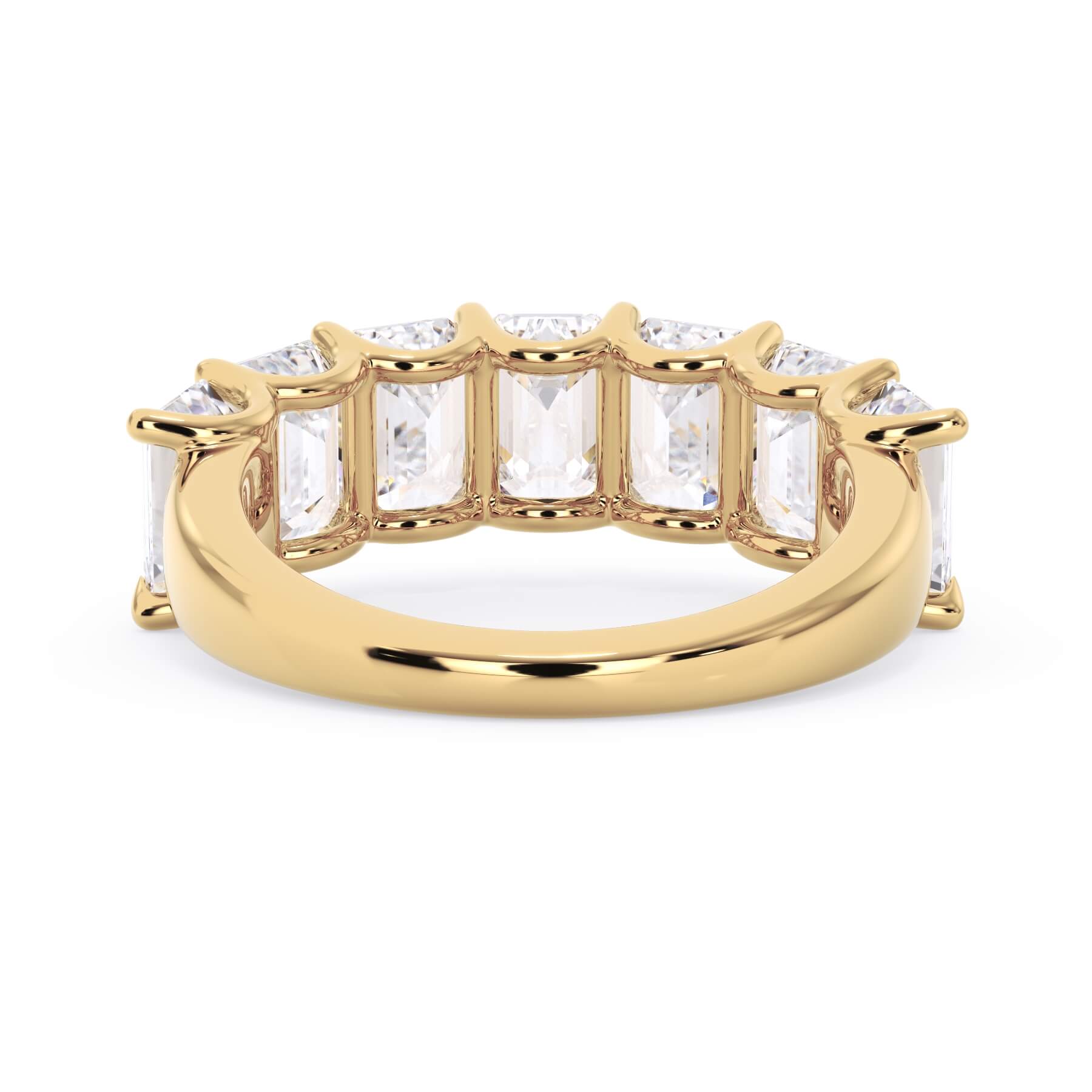 A picture of a seven stone diamond wedding ring with emerald cut diamonds that are U prong set in yellow gold on a white background with a view of the underside of the ring.