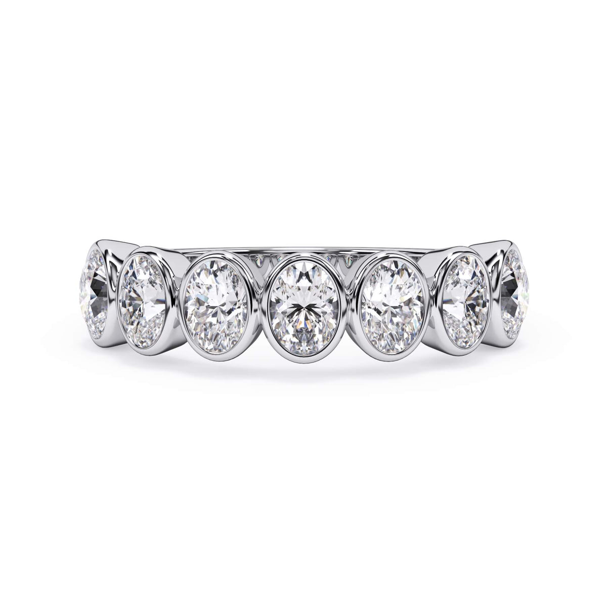 A picture of a seven stone diamond wedding ring with oval shaped diamonds that are bezel set in white gold or platinum on a white background with the ring facing forward, lying down.