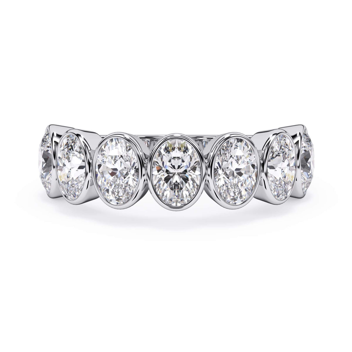 A picture of a seven stone diamond wedding ring with oval shaped diamonds that are bezel set in white gold or platinum on a white background with the ring facing forward, lying down.