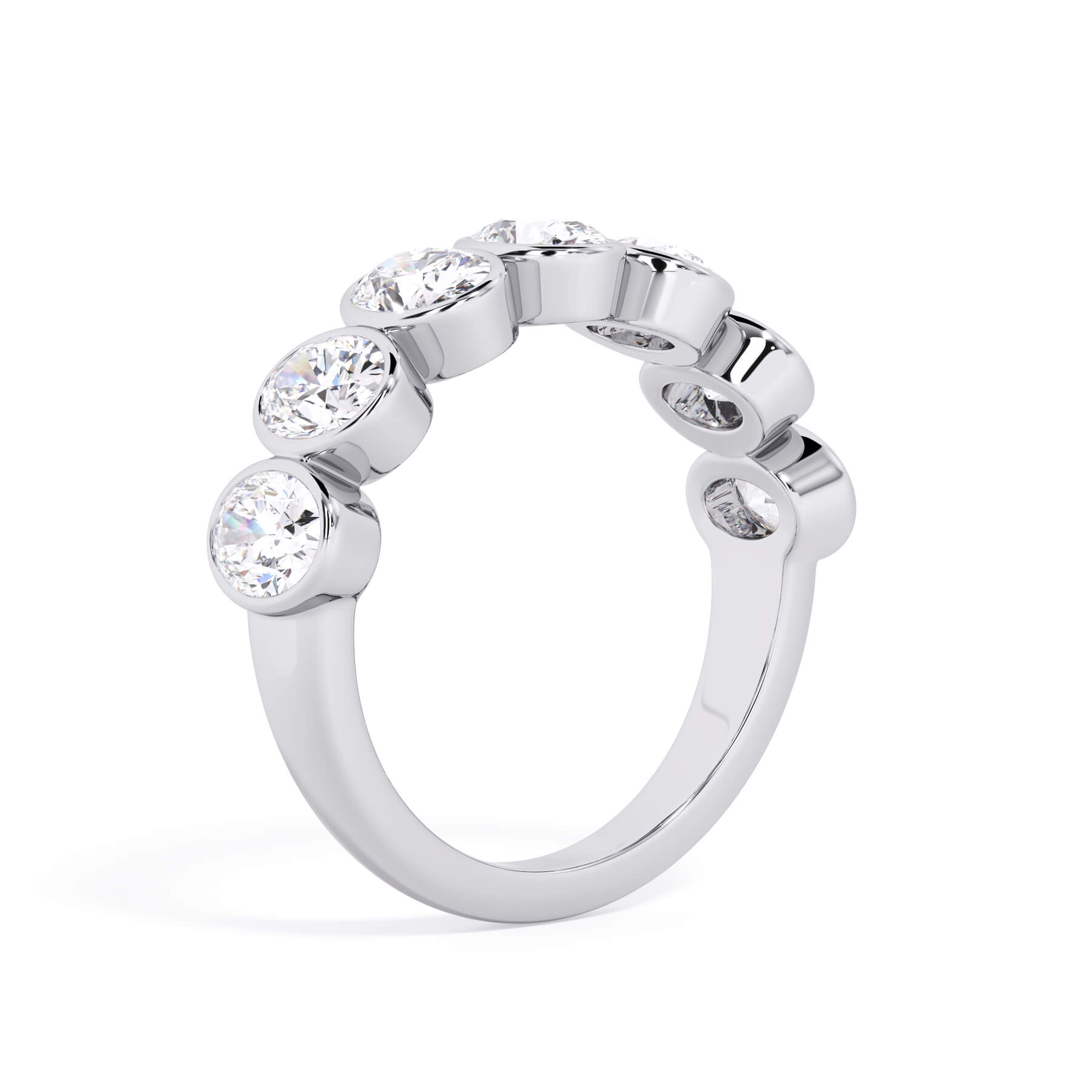 A picture of a seven stone diamond wedding ring with oval shaped diamonds that are bezel set in white gold or platinum on a white background with a slightly angled, through the finger view.