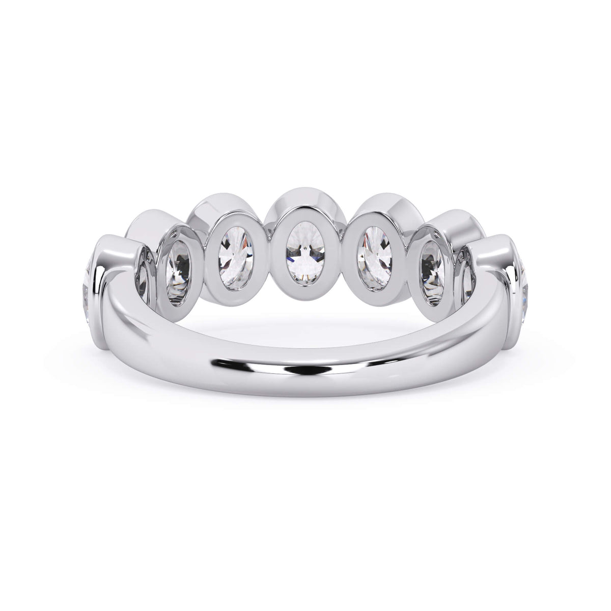 A picture of a seven stone diamond wedding ring with oval shaped diamonds that are bezel set in white gold or platinum on a white background with a view of the underside of the ring.