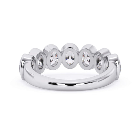 A picture of a seven stone diamond wedding ring with oval shaped diamonds that are bezel set in white gold or platinum on a white background with a view of the underside of the ring.