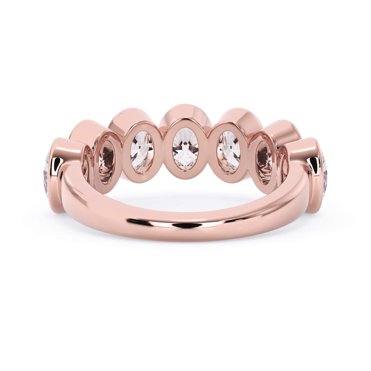 A picture of a seven stone diamond wedding ring with oval shaped diamonds that are bezel set in rose gold on a white background with a view of the underside of the ring.