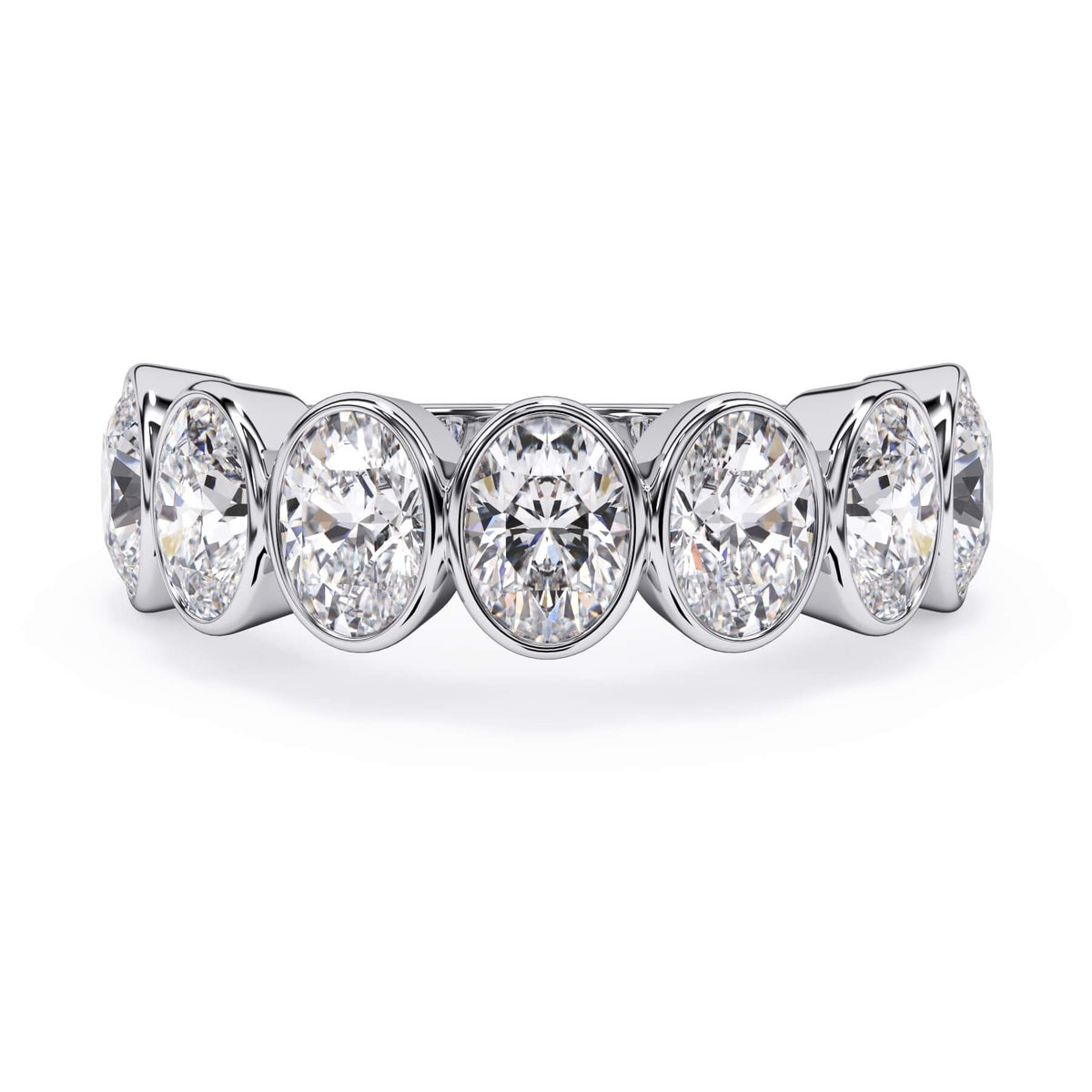 A picture of a seven stone diamond wedding ring with oval shaped diamonds that are bezel set in white gold or platinum on a white background with the ring facing forward, lying down.