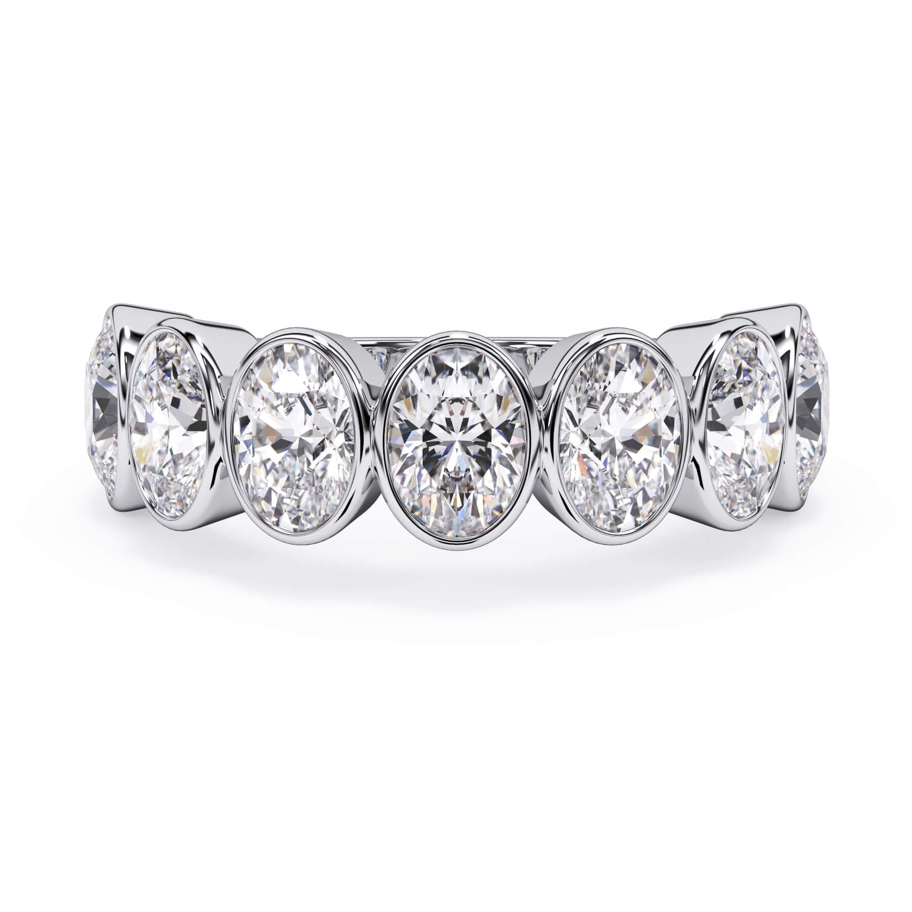 A picture of a seven stone diamond wedding ring with oval shaped diamonds that are bezel set in white gold or platinum on a white background with the ring facing forward, lying down.