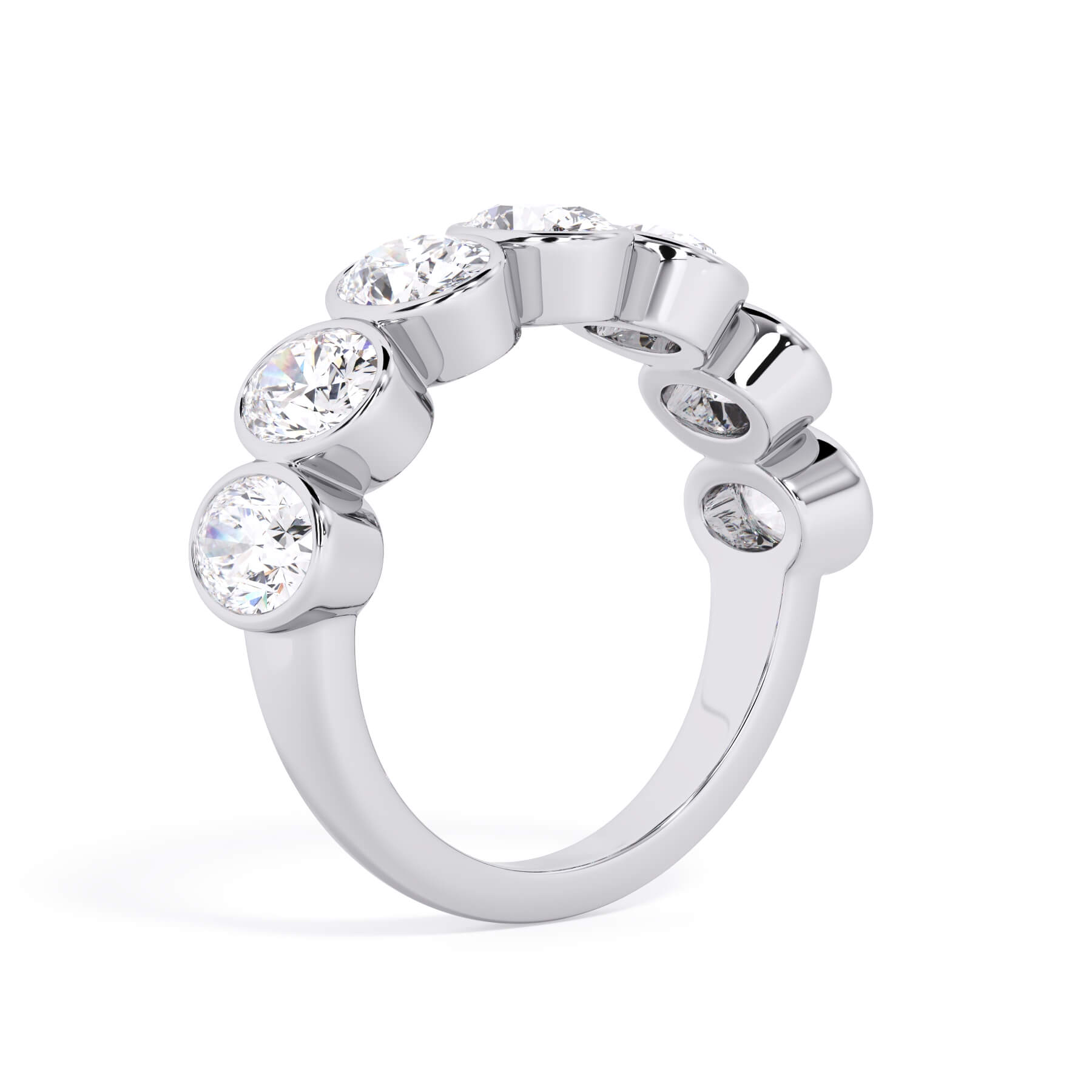 A picture of a seven stone diamond wedding ring with oval shaped diamonds that are bezel set in white gold or platinum on a white background with a slightly angled, through the finger view.