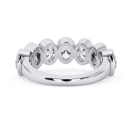 A picture of a seven stone diamond wedding ring with oval shaped diamonds that are bezel set in white gold or platinum on a white background with a view of the underside of the ring.