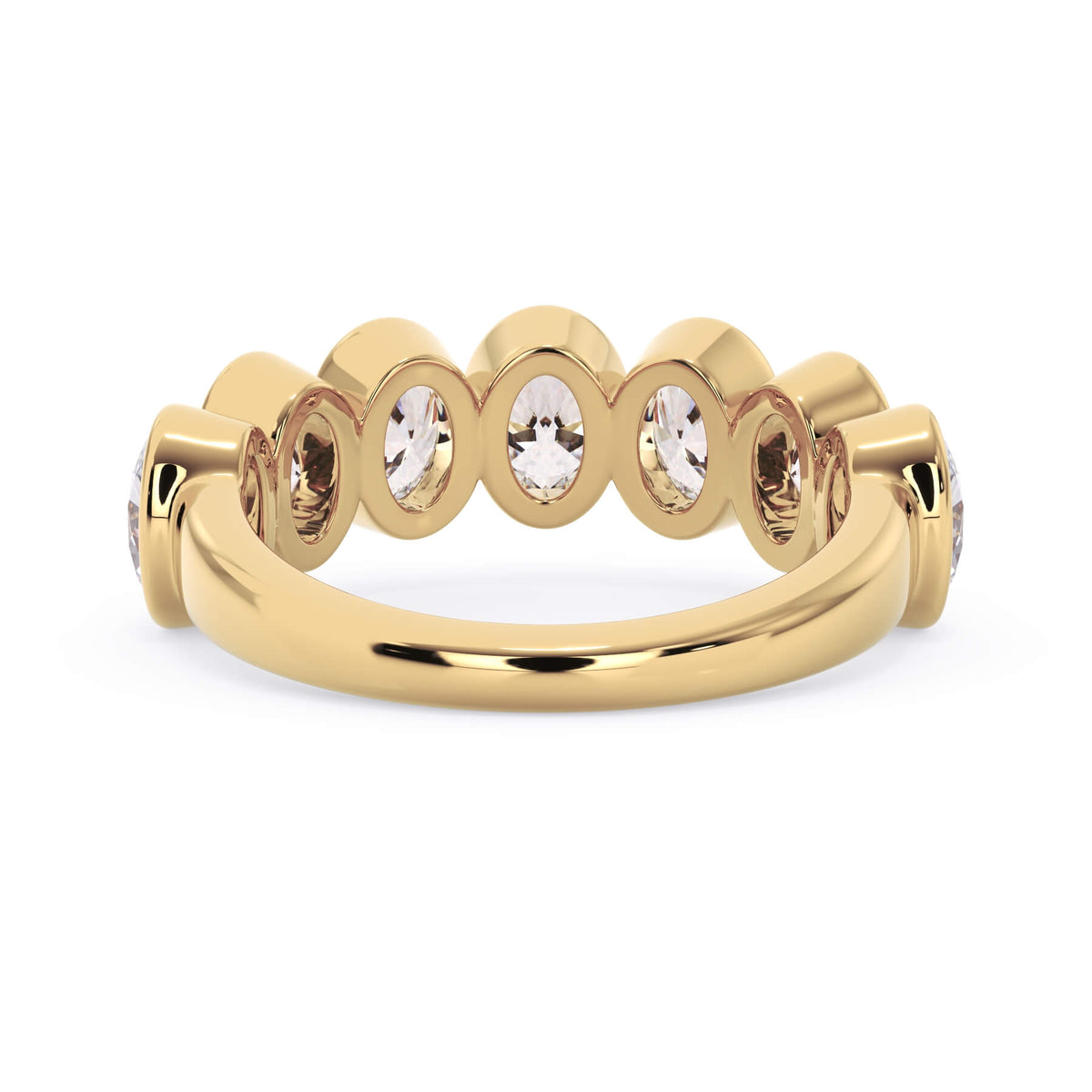 A picture of a seven stone diamond wedding ring with oval shaped diamonds that are bezel set in yellow gold on a white background with a view of the underside of the ring.