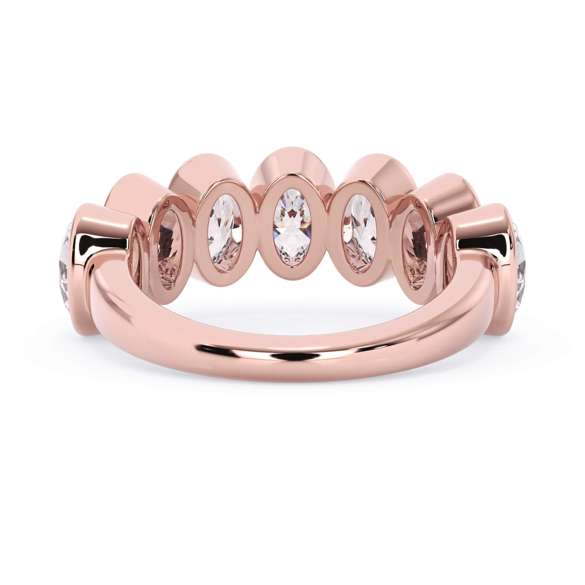 A picture of a seven stone diamond wedding ring with oval shaped diamonds that are bezel set in rose gold on a white background with a view of the underside of the ring.