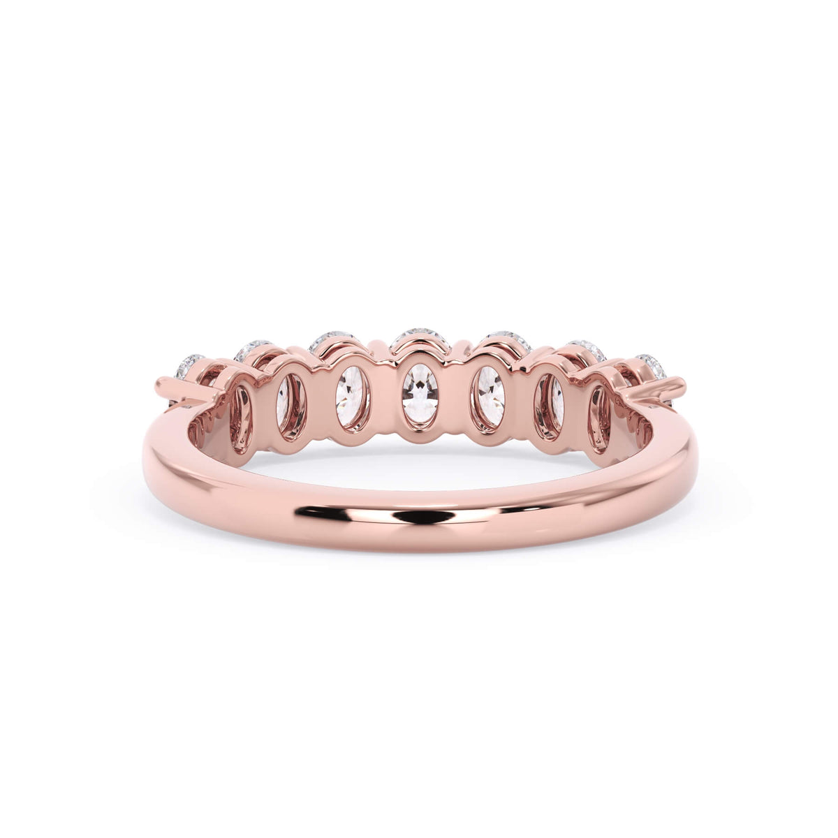 A picture of a seven stone diamond wedding ring with oval shaped diamonds that are shared prong set in rose gold on a white background with a view of the underside of the ring.