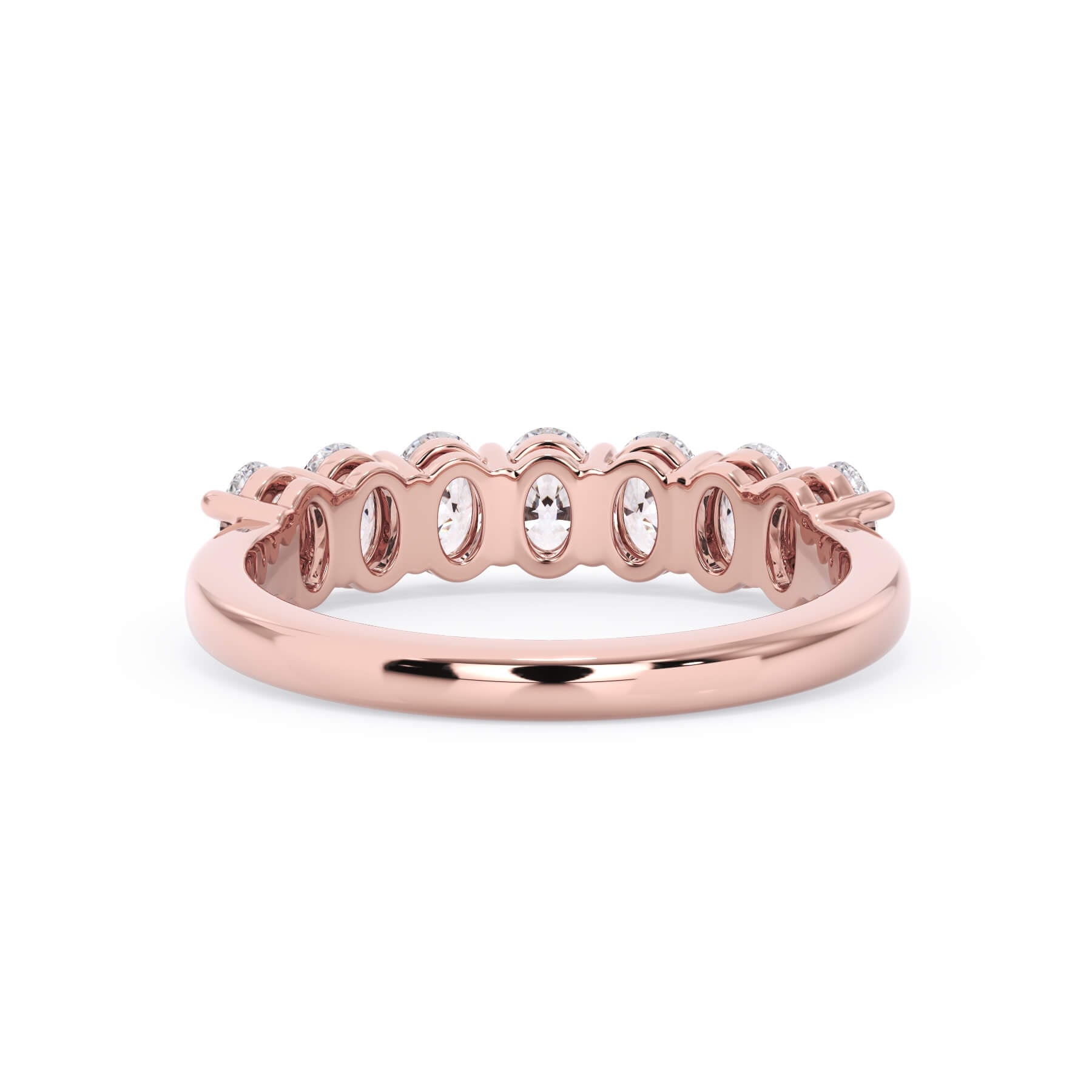 A picture of a seven stone diamond wedding ring with oval shaped diamonds that are shared prong set in rose gold on a white background with a view of the underside of the ring.