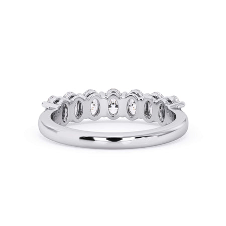 A picture of a seven stone diamond wedding ring with oval shaped diamonds that are shared prong set in white gold or platinum on a white background with a view of the underside of the ring.