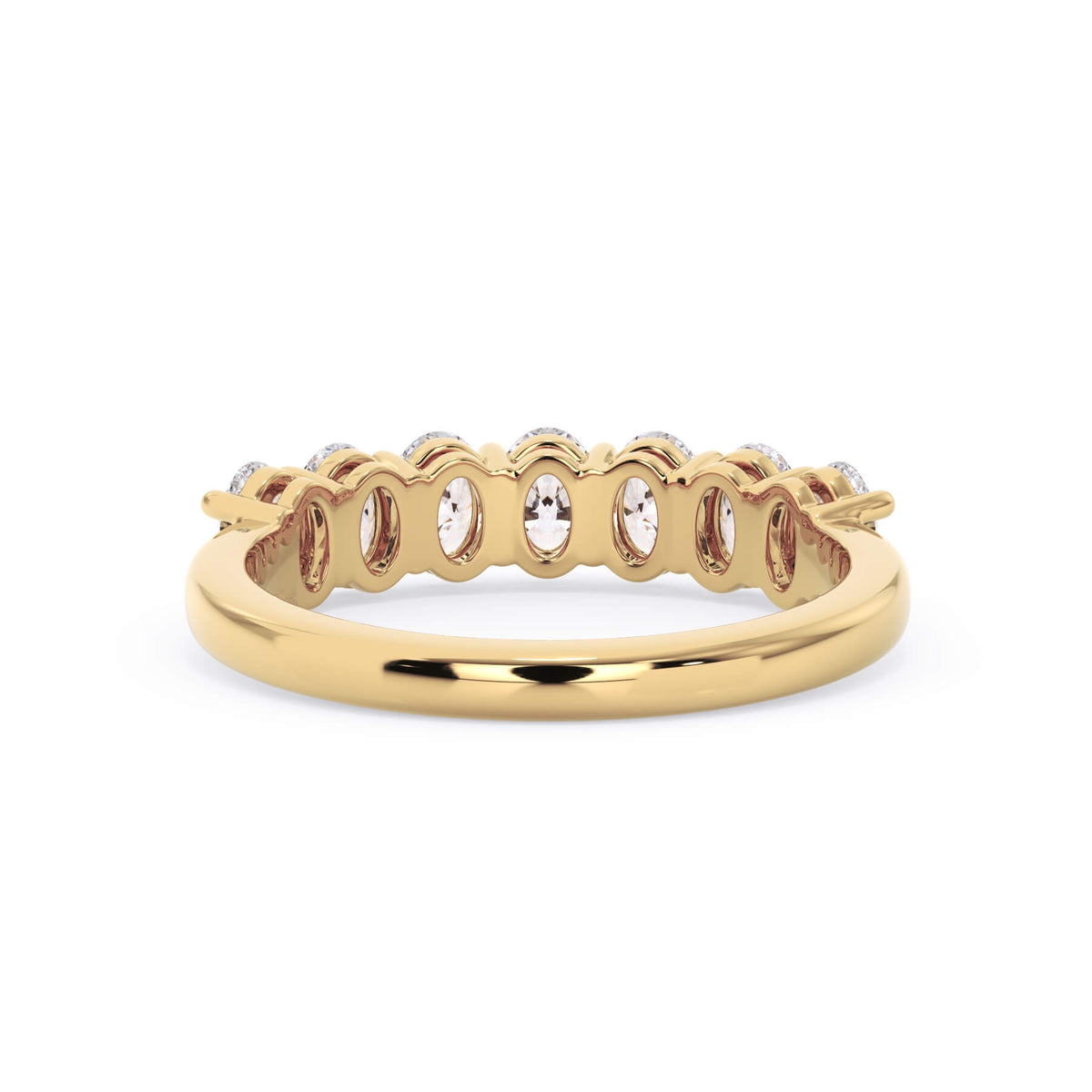 A picture of a seven stone diamond wedding ring with oval shaped diamonds that are shared prong set in yellow gold on a white background with a view of the underside of the ring.