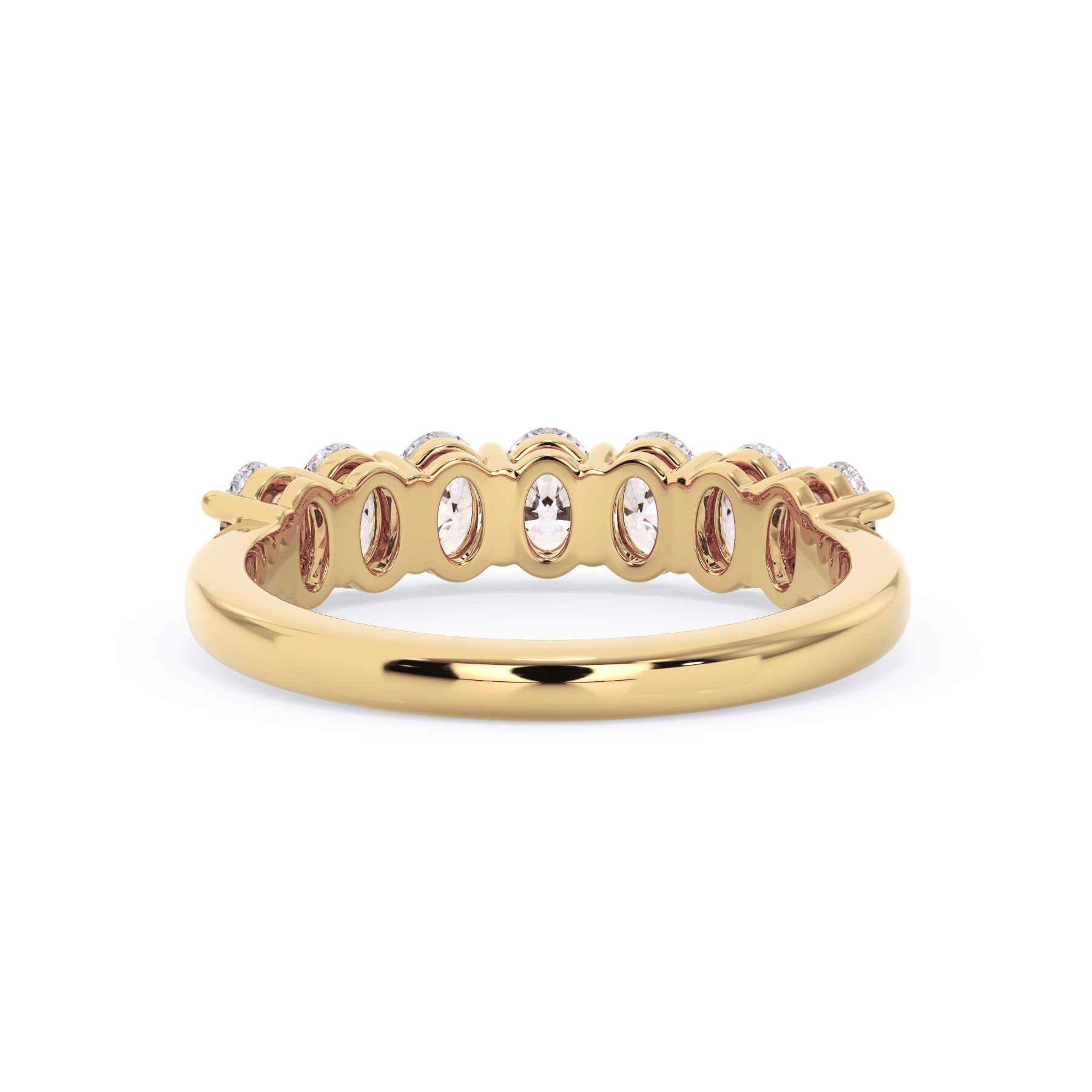 A picture of a seven stone diamond wedding ring with oval shaped diamonds that are shared prong set in yellow gold on a white background with a view of the underside of the ring.