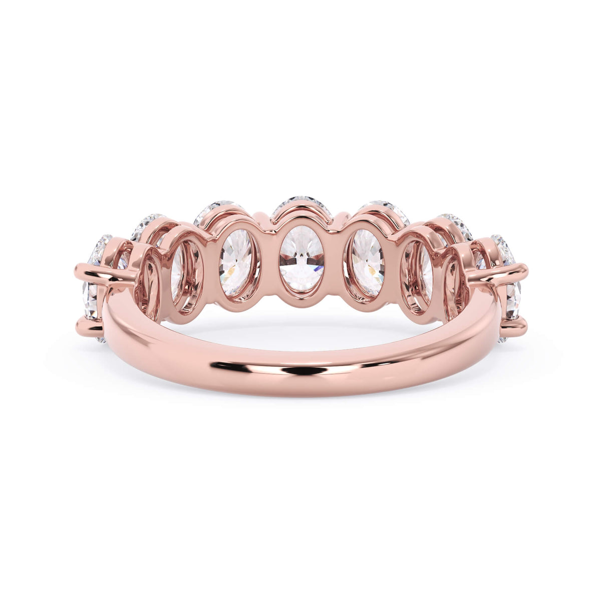 A picture of a seven stone diamond wedding ring with oval shaped diamonds that are shared prong set in rose gold on a white background with a view of the underside of the ring.