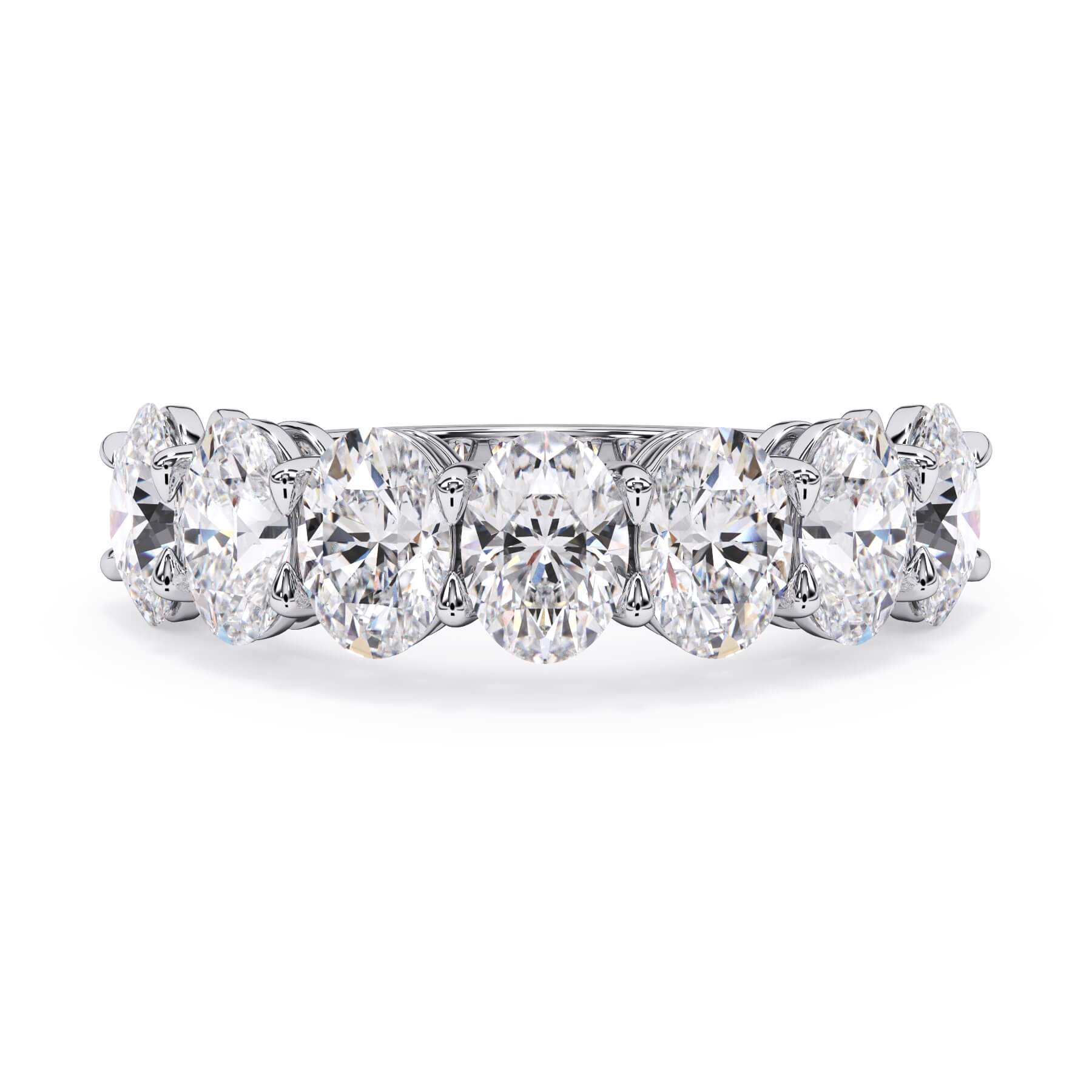 A picture of a seven stone diamond wedding ring with oval shaped diamonds that are shared prong set in white gold or platinum on a white background with the ring facing forward, lying down.