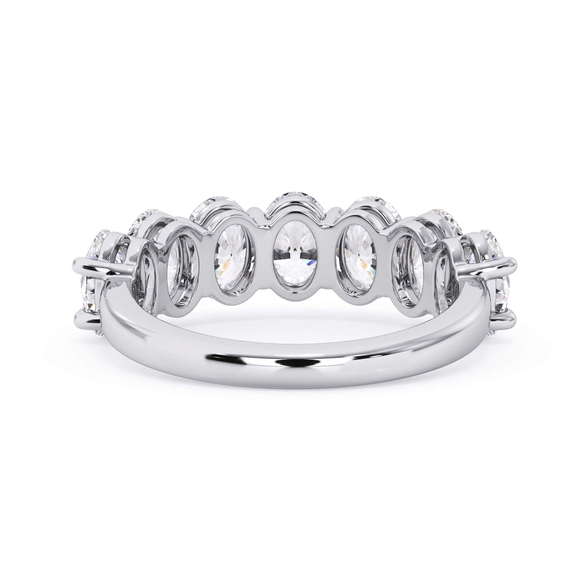 A picture of a seven stone diamond wedding ring with oval shaped diamonds that are shared prong set in white gold or platinum on a white background with a view of the underside of the ring.