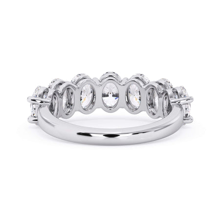 A picture of a seven stone diamond wedding ring with oval shaped diamonds that are shared prong set in white gold or platinum on a white background with a view of the underside of the ring.