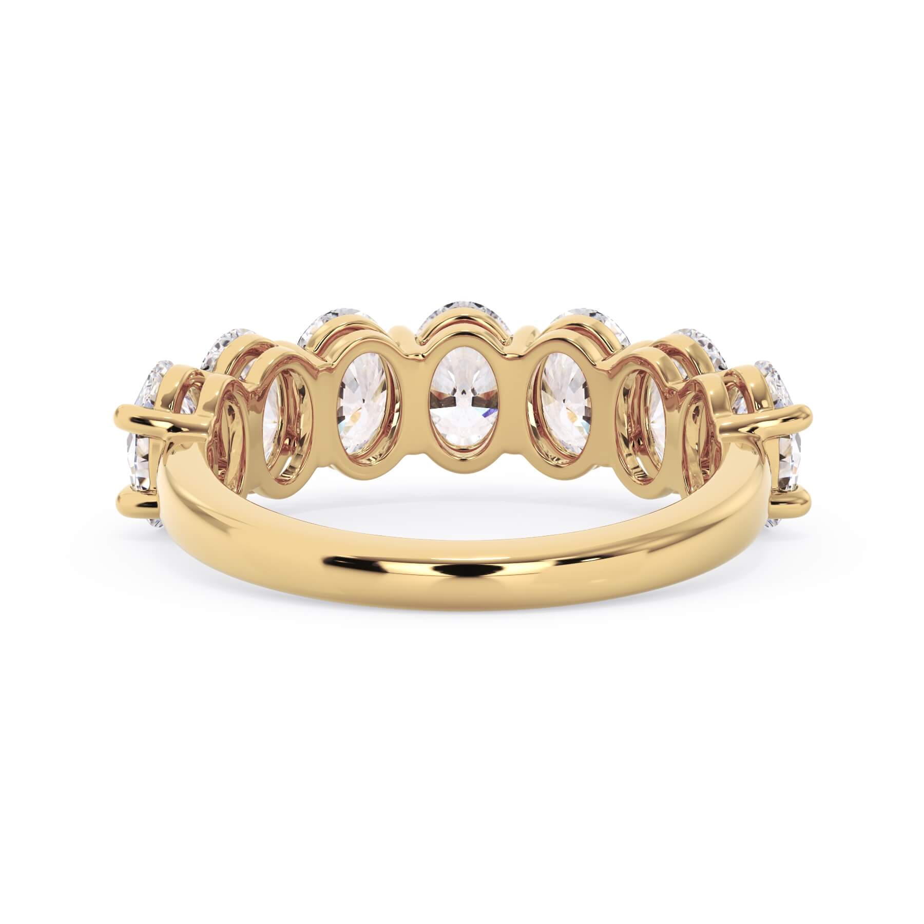 A picture of a seven stone diamond wedding ring with oval shaped diamonds that are shared prong set in yellow gold on a white background with a view of the underside of the ring.