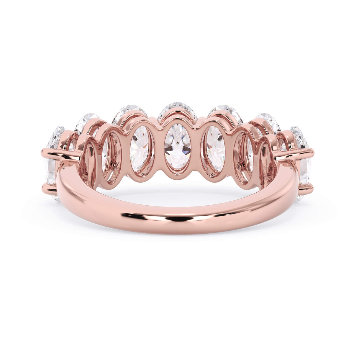 A picture of a seven stone diamond wedding ring with oval shaped diamonds that are shared prong set in rose gold on a white background with a view of the underside of the ring.