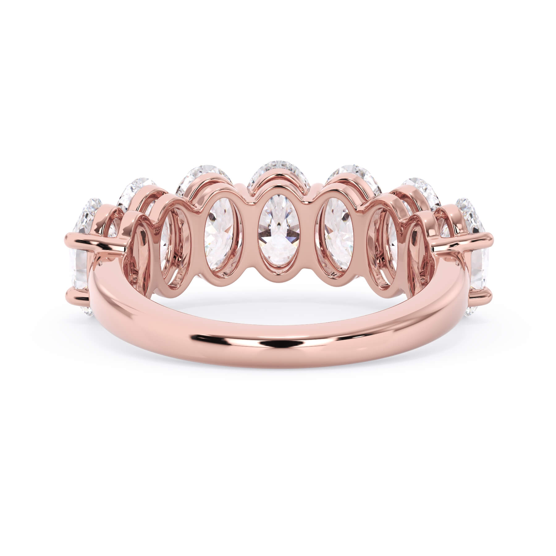 A picture of a seven stone diamond wedding ring with oval shaped diamonds that are shared prong set in rose gold on a white background with a view of the underside of the ring.