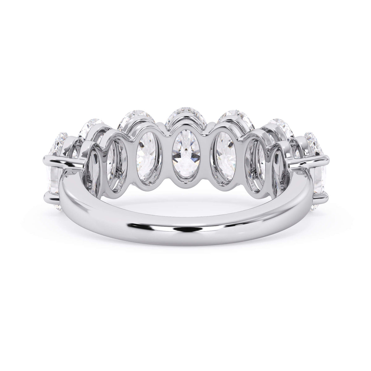 A picture of a seven stone diamond wedding ring with oval shaped diamonds that are shared prong set in white gold or platinum on a white background with a view of the underside of the ring.